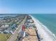 Stunning aerial view of the property with beach access, ocean views, and nearby coastal homes, an ideal coastal retreat at 2800 Gulf Blvd Unit # 1A, Belleair Beach, FL 33786