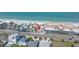 Aerial view showcasing beachfront property with parking, nearby street, and coastal charm, offering a prime location at 2800 Gulf Blvd Unit # 1A, Belleair Beach, FL 33786