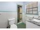 Bathroom featuring a toilet and shower at 2800 Gulf Blvd Unit # 1A, Belleair Beach, FL 33786