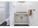 Bathroom with gray vanity, new light fixtures and shower at 2800 Gulf Blvd Unit # 1A, Belleair Beach, FL 33786