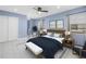 Bright bedroom with modern decor, ceiling fan, and large windows at 2800 Gulf Blvd Unit # 1A, Belleair Beach, FL 33786