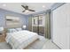 Serene bedroom with sliding glass doors to patio and a ceiling fan at 2800 Gulf Blvd Unit # 1A, Belleair Beach, FL 33786