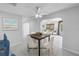 Dining room with modern table and chairs featuring an adjacent seating area with natural light at 2800 Gulf Blvd Unit # 1A, Belleair Beach, FL 33786