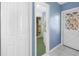 Hallway view leading to a bathroom with a shower, a closet, and an exterior door at 2800 Gulf Blvd Unit # 1A, Belleair Beach, FL 33786