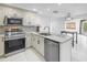 Kitchen featuring stainless steel appliances, white cabinetry and marble countertops at 2800 Gulf Blvd Unit # 1A, Belleair Beach, FL 33786