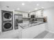 Well-lit kitchen features stainless steel appliances, white cabinetry and marble countertops at 2800 Gulf Blvd Unit # 1A, Belleair Beach, FL 33786