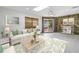 Comfortable living area with stylish furnishings and a tranquil view of the backyard at 2800 Gulf Blvd Unit # 1A, Belleair Beach, FL 33786