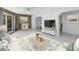 Charming living space featuring a stone wall, backyard view, comfortable furnishings, and open layout at 2800 Gulf Blvd Unit # 1A, Belleair Beach, FL 33786