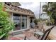 Cozy outdoor patio with comfortable seating and a view of the lush surroundings at 2800 Gulf Blvd Unit # 1A, Belleair Beach, FL 33786