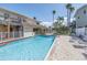 Inviting pool with lounge chairs for relaxation amidst lush landscaping, a perfect spot to enjoy the sun and unwind at 2800 Gulf Blvd Unit # 1A, Belleair Beach, FL 33786