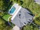 Aerial view of a backyard featuring a luxurious pool and patio at 29540 Chapel Park Dr, Wesley Chapel, FL 33543