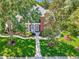 Aerial view of a brick two story home featuring manicured landscaping and a walkway at 29540 Chapel Park Dr, Wesley Chapel, FL 33543
