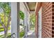 Outdoor balcony with brick columns and black iron railings at 29540 Chapel Park Dr, Wesley Chapel, FL 33543