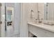 Bright bathroom with a white vanity, shower with glass doors, and decorative tile floors at 29540 Chapel Park Dr, Wesley Chapel, FL 33543