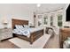 Bright bedroom with a large window, a wooden bed frame, and a unique desk area at 29540 Chapel Park Dr, Wesley Chapel, FL 33543