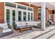 Inviting covered patio with stylish seating and brick architecture at 29540 Chapel Park Dr, Wesley Chapel, FL 33543
