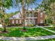 Beautiful brick home with a manicured lawn and a symmetrical design at 29540 Chapel Park Dr, Wesley Chapel, FL 33543