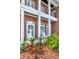 Welcoming front porch with white rocking chairs and lush green landscaping at 29540 Chapel Park Dr, Wesley Chapel, FL 33543