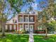 Beautiful red brick home featuring a second story balcony and landscaped front yard at 29540 Chapel Park Dr, Wesley Chapel, FL 33543