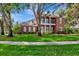 Exterior view of a stately brick home featuring a lush lawn and traditional architectural details at 29540 Chapel Park Dr, Wesley Chapel, FL 33543