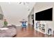 Game room featuring bean bag chairs, foosball table, a mounted flat screen TV and ceiling fan at 29540 Chapel Park Dr, Wesley Chapel, FL 33543