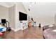 Spacious game room with wood floors, bean bag chairs, arcade game, and a large flat screen TV at 29540 Chapel Park Dr, Wesley Chapel, FL 33543