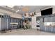 Organized garage features gray slat walls, storage cabinets, and a home gym area at 29540 Chapel Park Dr, Wesley Chapel, FL 33543