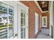 Hallway with a red brick wall, white doors, and a wooden ceiling at 29540 Chapel Park Dr, Wesley Chapel, FL 33543