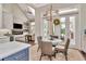 A sunlit kitchen has an island, a breakfast table, and access to the back patio at 29540 Chapel Park Dr, Wesley Chapel, FL 33543