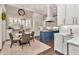 Bright kitchen with white cabinetry, stainless steel appliances, and adjacent breakfast nook at 29540 Chapel Park Dr, Wesley Chapel, FL 33543