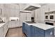 A well-equipped kitchen features a large blue island and modern appliances at 29540 Chapel Park Dr, Wesley Chapel, FL 33543