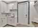 Well-lit laundry room with cabinets, sink, and door to the outside at 29540 Chapel Park Dr, Wesley Chapel, FL 33543