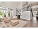 Open-plan living room showcasing a staircase with wrought iron railings, and views to kitchen and front entrance at 29540 Chapel Park Dr, Wesley Chapel, FL 33543