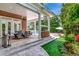 Covered patio with an outdoor kitchen and dining table overlooking the manicured backyard and pool at 29540 Chapel Park Dr, Wesley Chapel, FL 33543