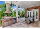 Outdoor kitchen and dining area with stainless steel appliances, and a view of the lush backyard at 29540 Chapel Park Dr, Wesley Chapel, FL 33543