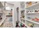 A well-organized pantry provides ample storage with shelving and wire baskets at 29540 Chapel Park Dr, Wesley Chapel, FL 33543