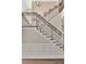 Elegant staircase with decorative iron railings and wainscoting, offering an upscale feel at 29540 Chapel Park Dr, Wesley Chapel, FL 33543