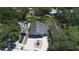 Aerial view of this home showing mature trees and a paved driveway featuring a central landscaping feature at 3105 Gordon Ct, Tampa, FL 33619