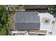 Birds-eye view of a home with a dark roof and overgrown yard, showcasing the property's layout at 3105 Gordon Ct, Tampa, FL 33619