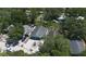 An aerial shot of this home showcasing its shingled roof, foliage, and its paved driveway at 3105 Gordon Ct, Tampa, FL 33619