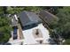 Aerial view of a home with a screened porch, tidy landscaping, and a long driveway at 3105 Gordon Ct, Tampa, FL 33619