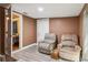 The basement sitting area is cozy, with two comfortable chairs at 3105 Gordon Ct, Tampa, FL 33619