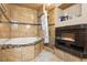 Elegant bathroom with a tiled surround tub, separate shower and fireplace adding luxury to the space at 3105 Gordon Ct, Tampa, FL 33619