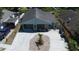 Light blue home featuring a new driveway, mature landscaping and a covered porch with seating at 3105 Gordon Ct, Tampa, FL 33619