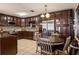 Spacious kitchen featuring dark wood cabinets, stainless steel appliances, and a dinette set at 3105 Gordon Ct, Tampa, FL 33619
