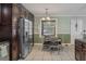 Open kitchen and dinette area featuring dark wood cabinets and stainless steel appliances at 3105 Gordon Ct, Tampa, FL 33619