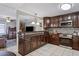 Modern kitchen featuring dark wood cabinets, granite countertops, stainless steel appliances and tiled backsplash at 3105 Gordon Ct, Tampa, FL 33619