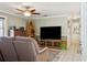 Comfortable living room featuring neutral paint, a ceiling fan, tile floors and a view into the hall at 3105 Gordon Ct, Tampa, FL 33619