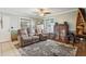 Comfortable living room featuring neutral paint, a ceiling fan, tile floors and a view into the hall at 3105 Gordon Ct, Tampa, FL 33619