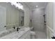 Elegant bathroom featuring a granite countertop, framed mirror, and a luxurious walk-in shower with a built-in bench at 324 3Rd N Ave, Safety Harbor, FL 34695